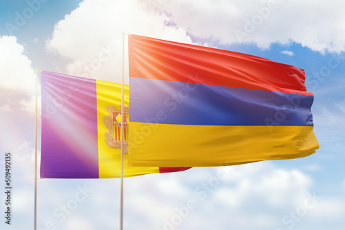 Sunny blue sky and flags of armenia and andorra