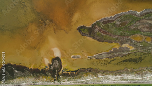 Fotografija Brown dirty lake with patterned shore