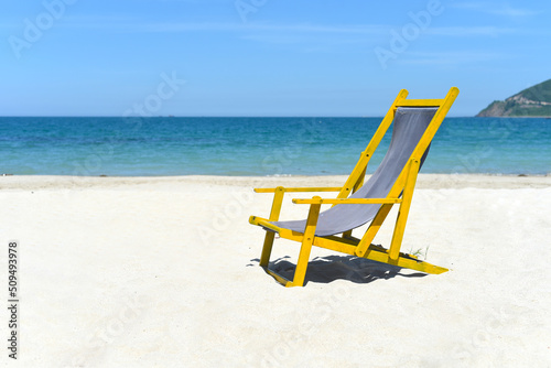 Wooden deck chair on white sand against south china sea in Nha Trang Vietnam