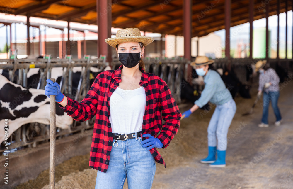 Portrait of confident young female farmer wearing face mask to protect against viral diseases 