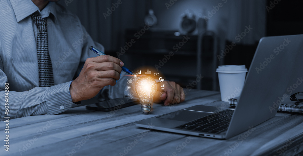 Businessman hand holding creative light bulb with marketing network icons on planning strategy, analysis solution and development, Modern business, Innovative of new ideas.