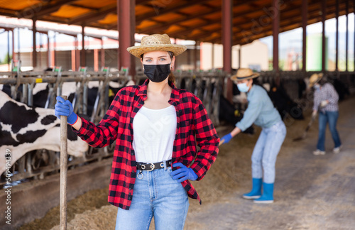 Portrait of confident young female farmer wearing face mask to protect against viral diseases 