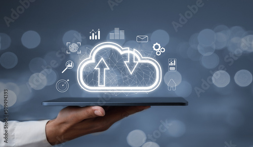 Creative background, a male hand with the iPad, the image of the hologram of the cloud, blue background. The concept of cloud technology, cloud storage, and a new generation of networks. Mixed media.