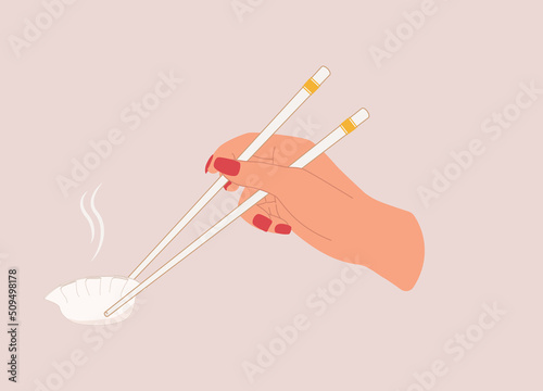 Female’s Hand Holding A Pair Of White Color Chopsticks With One Steamed Dumpling. Close-Up. Character, Cartoon.