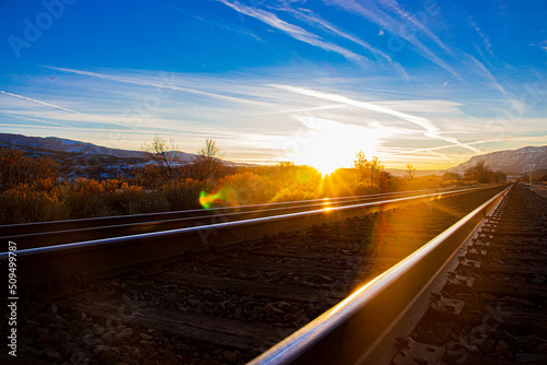 Railroad sunset in the rocky mountains with blue and orange skies