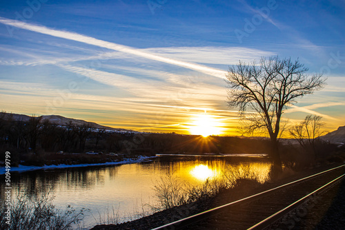 Railroad sunset in the rocky mountains with blue and orange skies