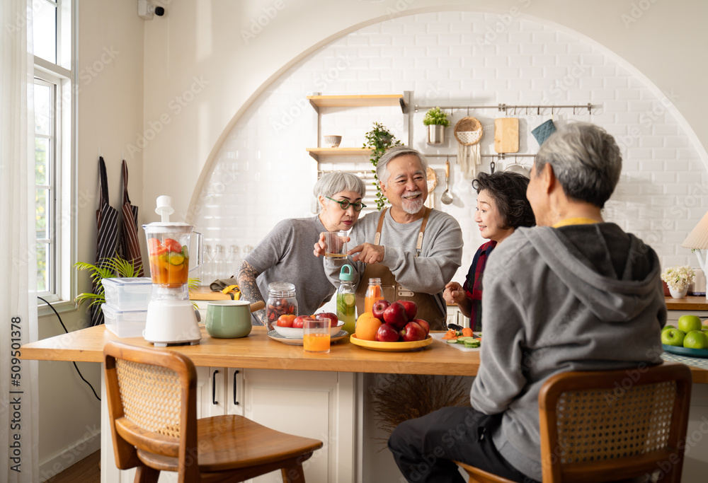 Group of Asian elder people friends making vegetables salad and fruit juice with her daughter in kitchen at home.concept of Group asia senior people Healthy eating,colorful fruits and vegetables. Group of Asian elder people friends making vegetables salad and fruit juice with her daughter in kitchen at home.concept of Group asia senior people Healthy eating,colorful fruits and vegetables.