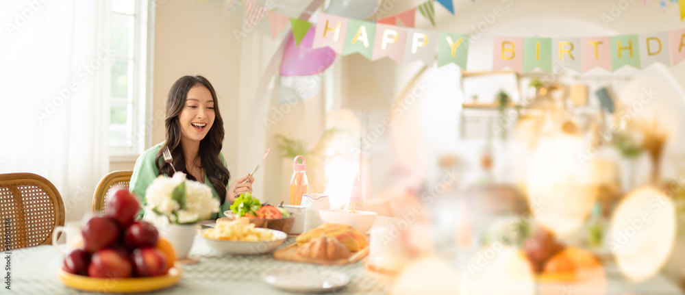 Beautiful happy asian woman her birthday in living room at home.Girl with cake.Birthday or New Year's eve celebration concept