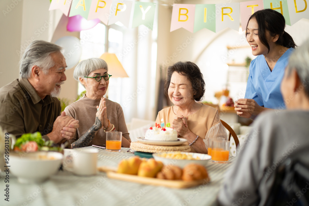 birthday party at senior in Adult Daycare Center concept.Group of asian elder people friends having birthday party in the living room at nursing home,enjoy,smile,happiness in birthday friend party