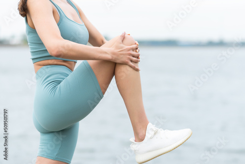 An athlete stretching her hamstring and hip flexor in a yoga pose.Getting ready for a workout