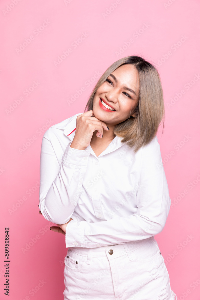 Portrait attractive asian woman feeling happy in front of a bright pink background. Portrait attractive asian woman feeling happy in front of a bright pink background.