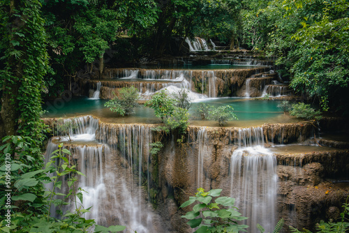 Beautiful waterfall in the tropical jungle at Kanchanaburi  Thailand. Emerald green waters in the forest.