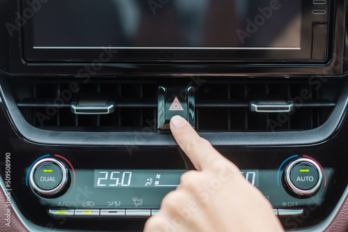 Finger presses the emergency stop button inside the car. Safety and transportation concept