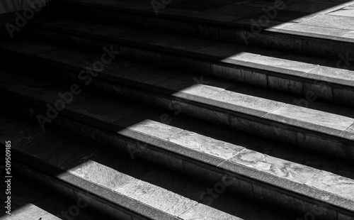 Shade and Sunlight on Vintage Marble Stairs in Monochrome.