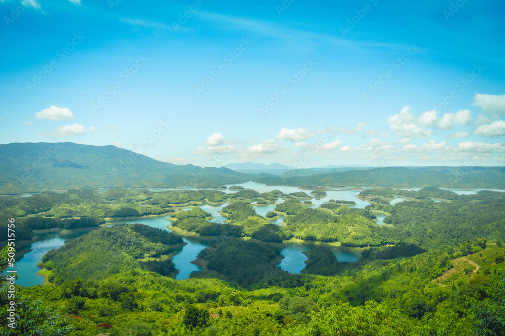 Obraz premium Morning at the Ta Dung lake or Dong Nai 3 lake with green hills and mountains. Travel and landscape concept. Travel concept.
