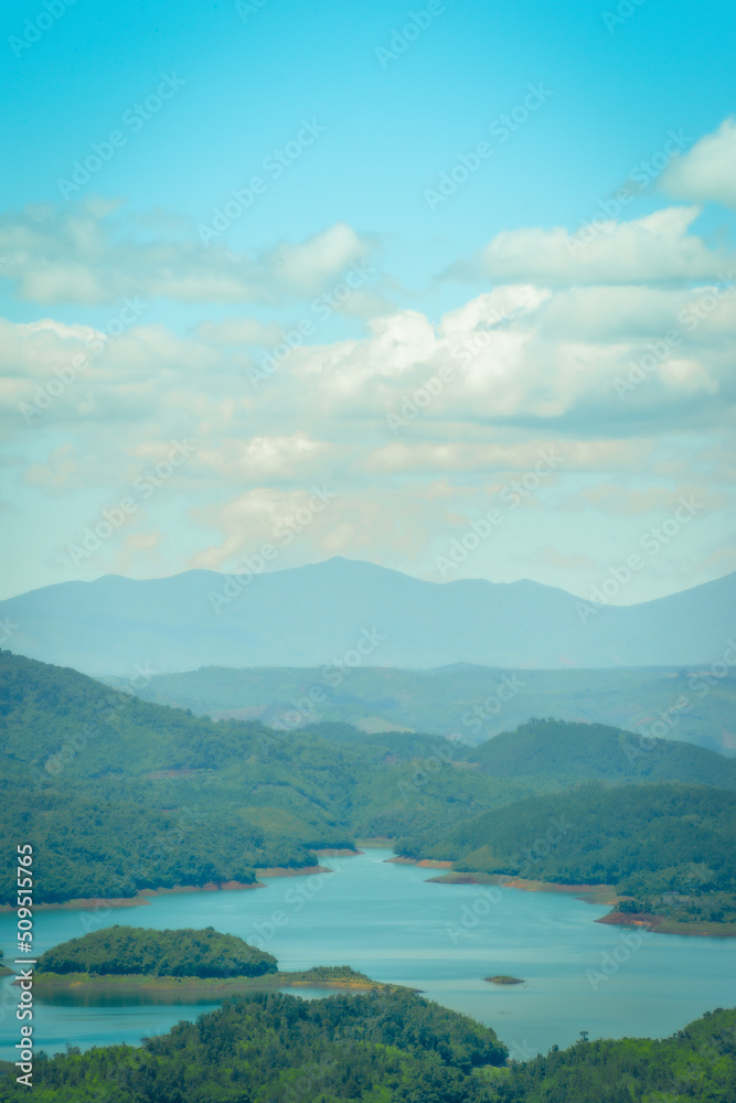Fototapeta premium Morning at the Ta Dung lake or Dong Nai 3 lake with green hills and mountains. Travel and landscape concept. Travel concept.