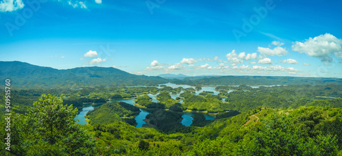 Morning at the Ta Dung lake or Dong Nai 3 lake with green hills and mountains. Travel and landscape concept. Travel concept. photo