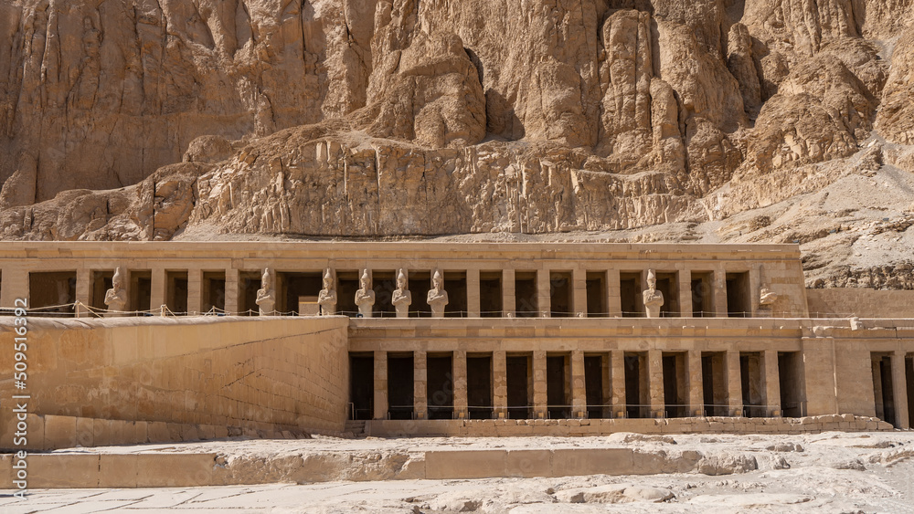 The funerary temple of the Pharaoh queen Hatshepsut is carved into a sheer cliff. Colonnades, terraces, statues are visible. Egypt. Luxor