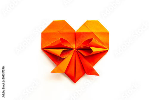 yellow heart made of origami paper on a white background. love concept