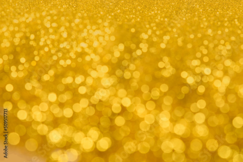 golden bokeh like shining star on gold background