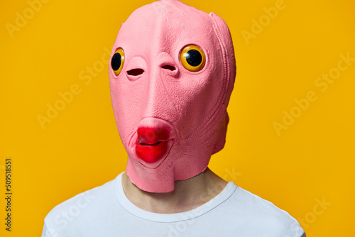 portrait of a man in a funny pink masquerade mask