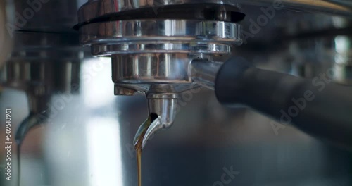 Fresh espresso coffee pouring from coffee machine