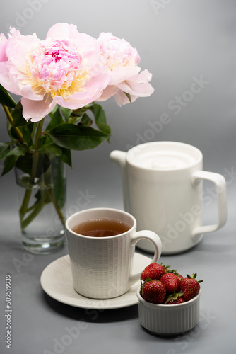 Сup of tea, peony and berries.