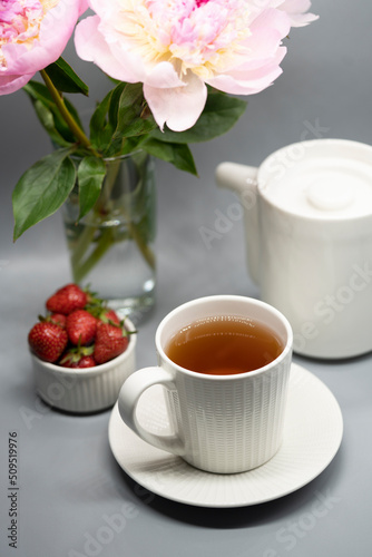 Сup of tea, peony and berries.