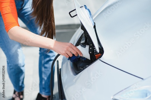 Woman is charging rental electric car © Serhii