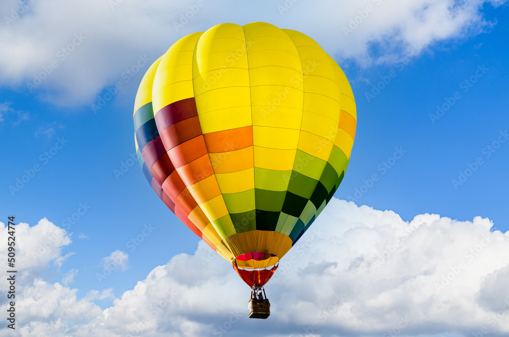 Naklejka premium Colorful hot air balloon flying over blue sky