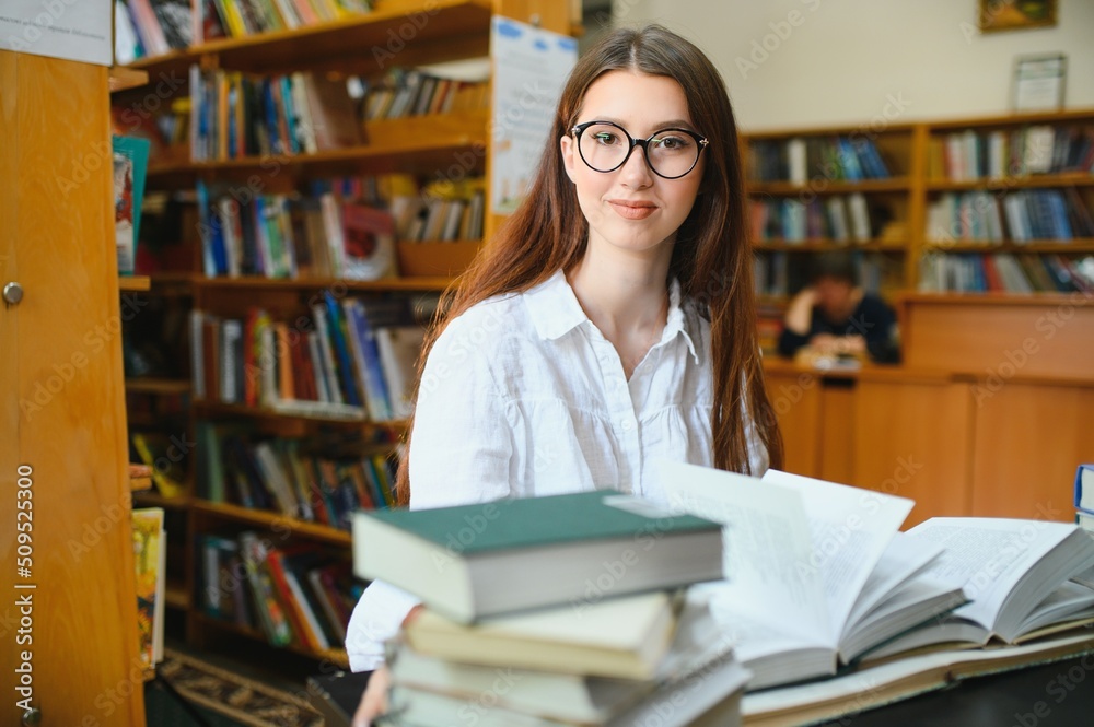 Portrait of a student girl studying at library
