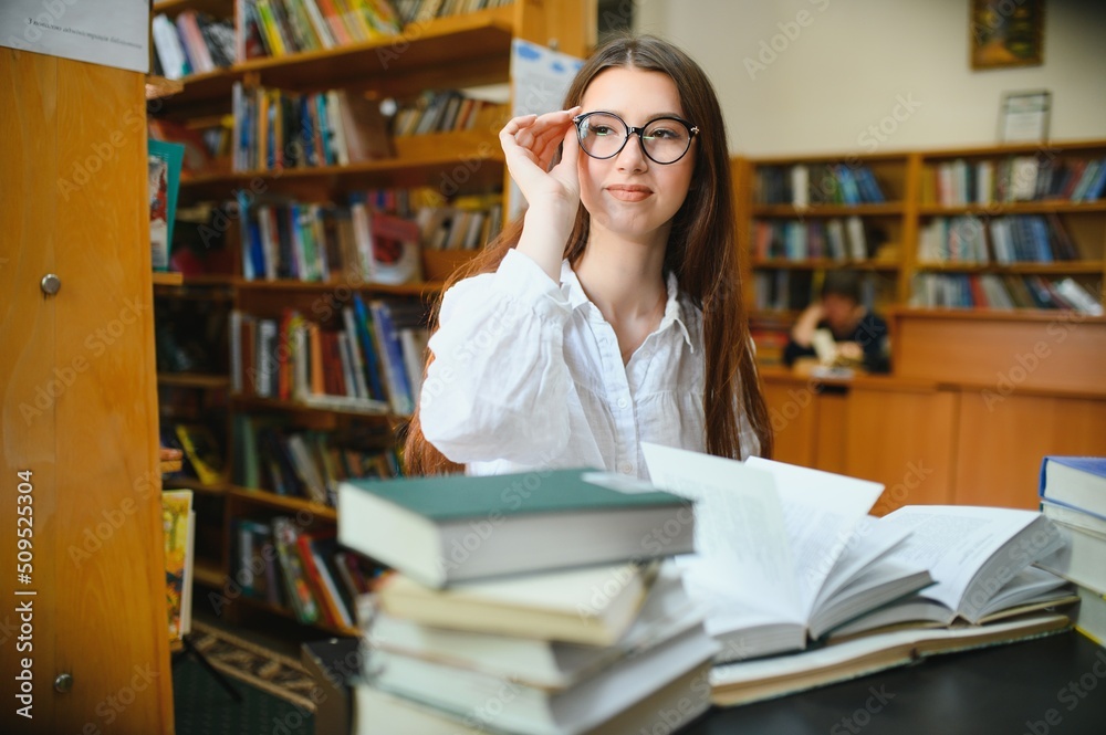Portrait of a student girl studying at library Portrait of a student girl studying at library