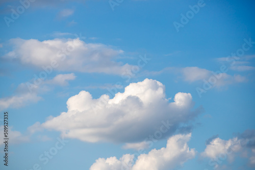 White clouds on the blue sky, bright background of the summer sky. © Prikhodko