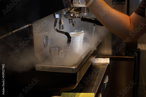 Close up view of preparing coffee espresso in automatic coffee machine in cafe