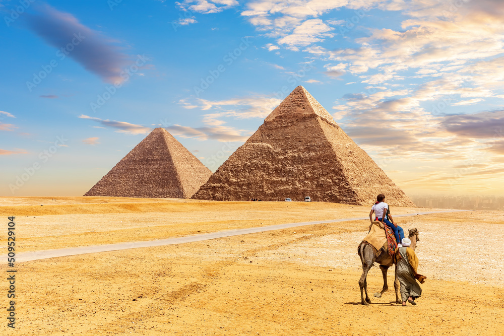 The Egypt Pyramids Khafre and Cheops and bedouin with tourists in the Giza desert