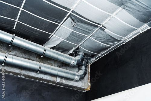 Covering the ceiling with thermal insulation materials. Construction of a ventilation system from metal pipes. Insulation and installation of air conditioning and heating systems at home. 