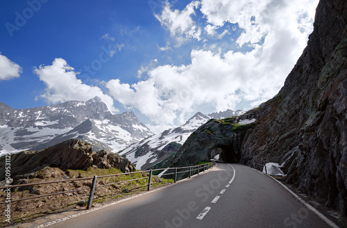 Asphalt road in Alp mountains. Road trip concept. Beautiful landscape.