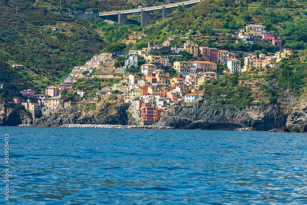 The famous Riomaggiore village, view from the sea, Cinque Terre National Park in Liguria, La Spezia province, Italy, southern Europe. UNESCO world heritage site.