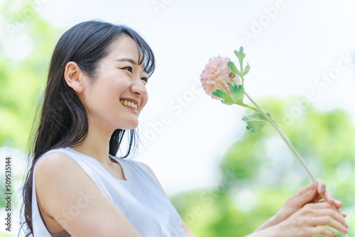一輪の花を持つ女性 