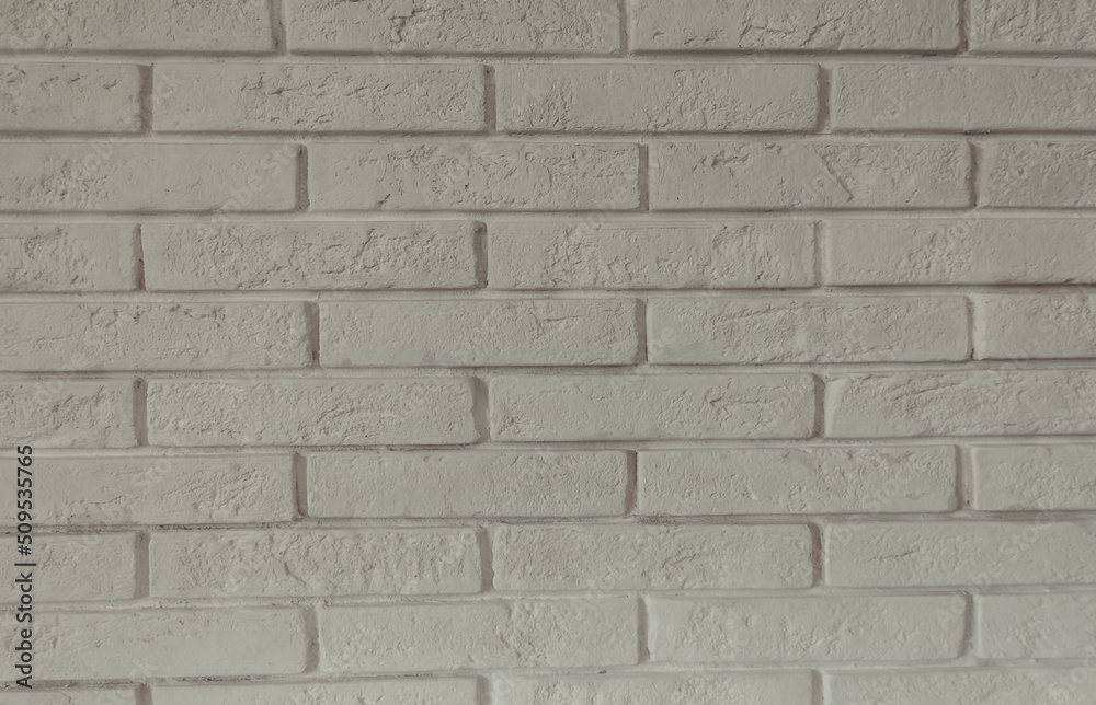 White decorative brick wall close up. Horizontal brick tile texture background. Scandinavian interior. White decorative brick wall close up. Horizontal brick tile texture background. Scandinavian interior.