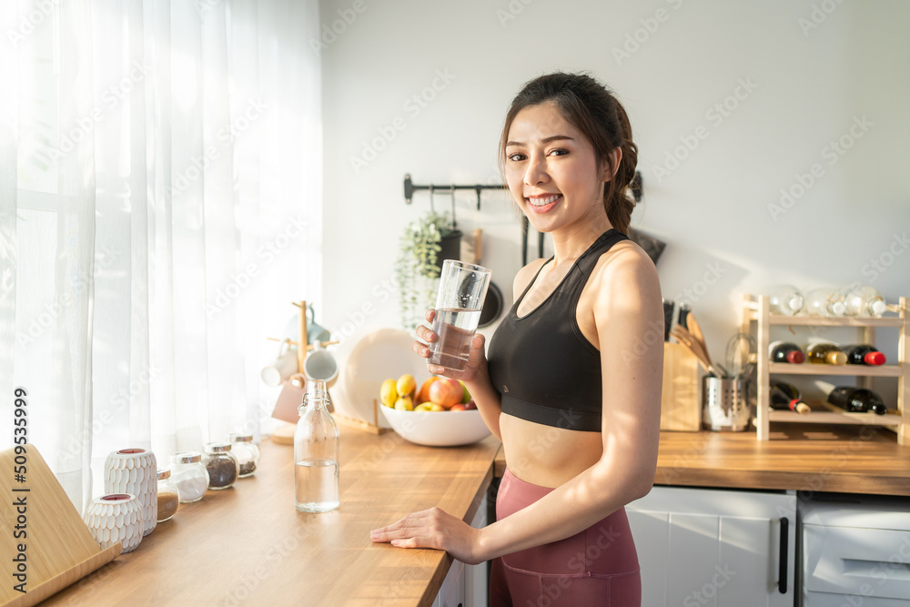 Portrait of Asian beautiful woman drink water after exercise at home. Portrait of Asian beautiful woman drink water after exercise at home.