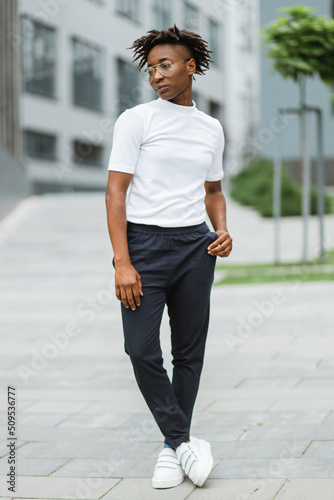 Beautiful young woman in a city. African american girl looking outside camera. People, lifestyle, busibess, city life, beauty concept.