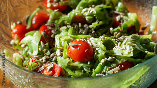 Green beans salad with sunflower seeds, tomatoes, flax seeds, and sesames.  photo