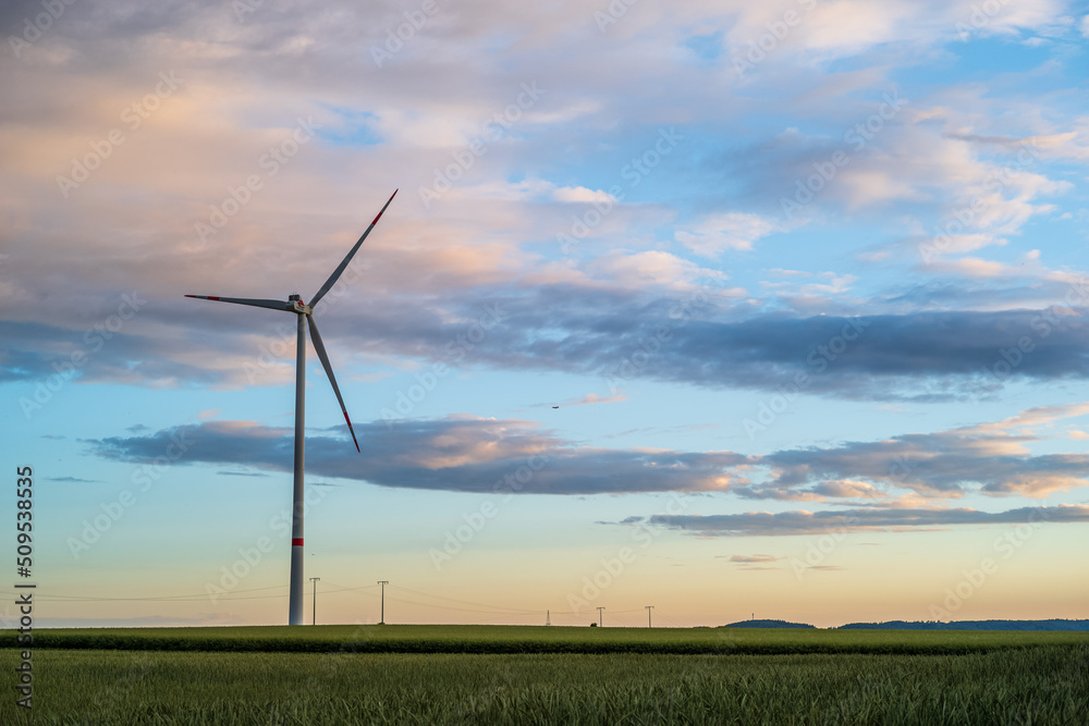Obraz premium wind turbine at sunset