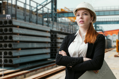 woman civil engineer or safety inspector at construction site