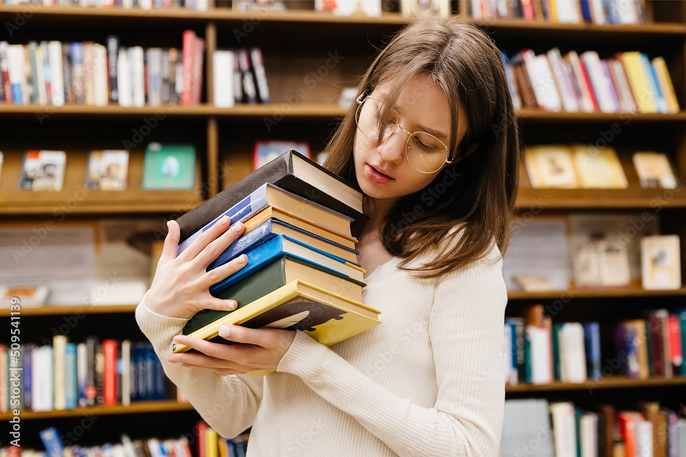 Beautiful female student in a college library Beautiful female student in a college library