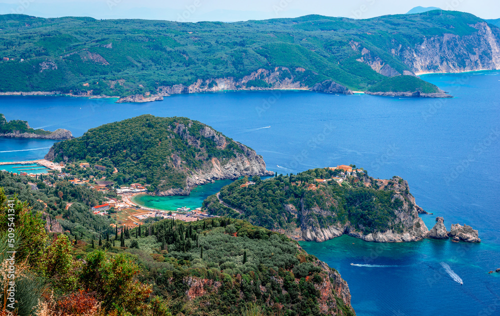 Scenic landscape of the Paleokastritsa era in Corfu, Greece, with crystal clear water and rocky coves. Breathtaking view from Angelokastro castle.