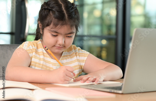 Asian girls are studying in tutoring, studying online at home, girls are bored and tired from tutoring.