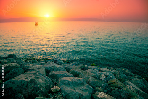 Stampa su tela Rocky shore of the Sea of Galilee at sunrise
