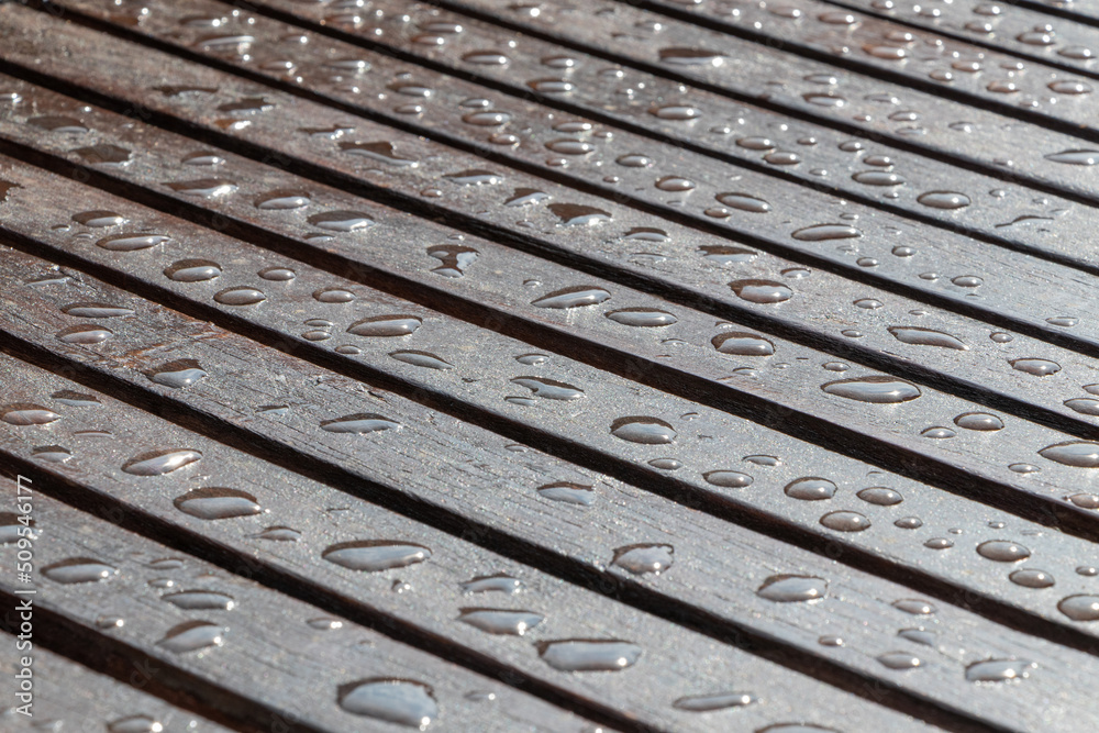 Rain drops on wooden table after rain. Selective focus